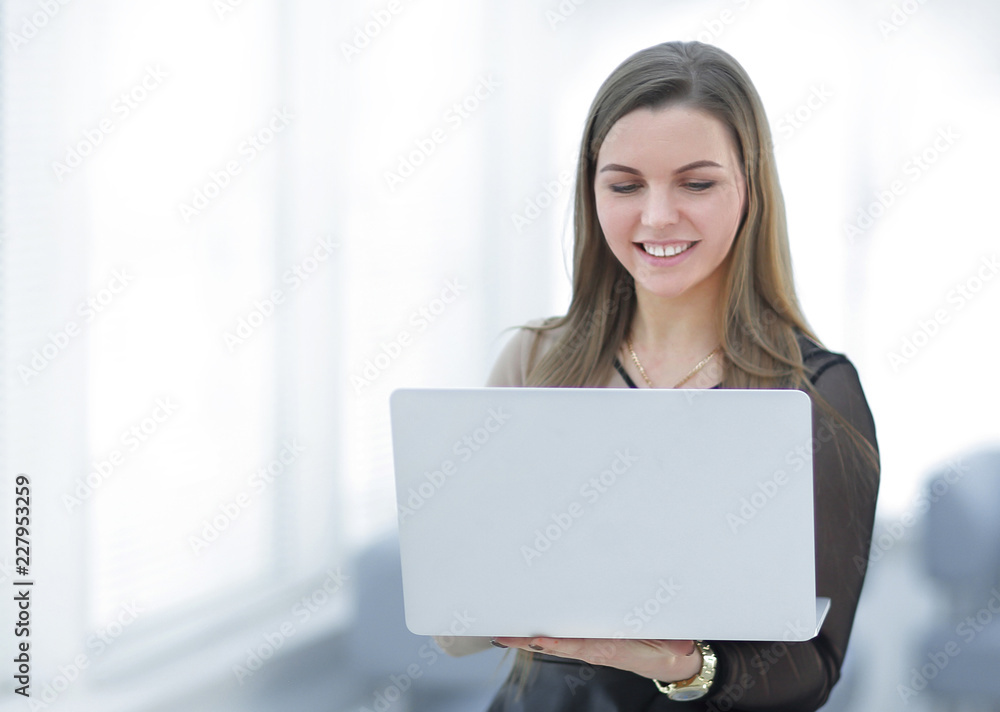young business woman with laptop standing in office lobby young business woman with laptop standing in office lobby