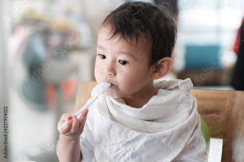 Children is eating yogurt in the morning.
