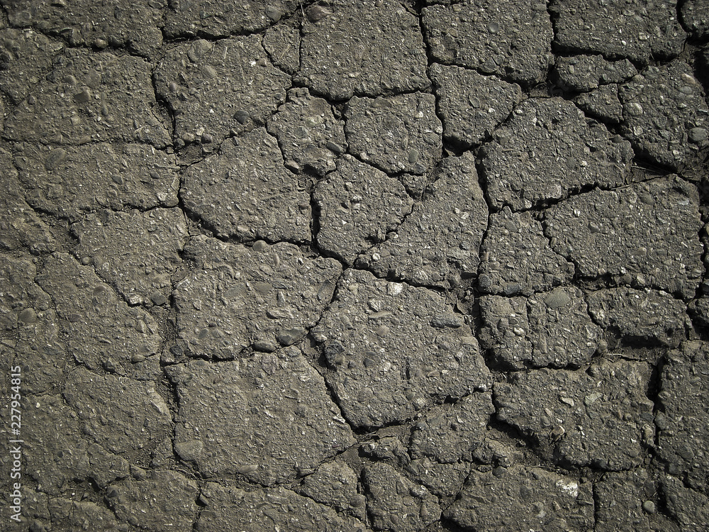 Old worn and cracked asphalt with cracks. Cracked asphalt background Old worn and cracked asphalt with cracks. Cracked asphalt background