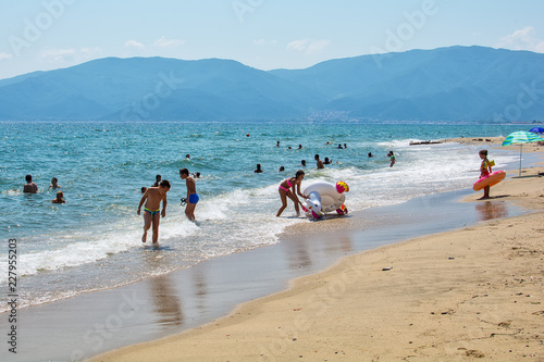 Asprovalta, Greece - August 20, 2018: Asprovalta and New Vrasna resort, Asprovalta beach. Sea view to Asprovalta at the foot of the green hills. photo