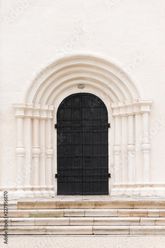 The big black door is the gate to the white building. Architectural details of the past. © Bakulov