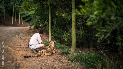 man with leopard in the zoo