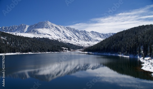 Snow covered mountains reflected in lake © ezpilot1