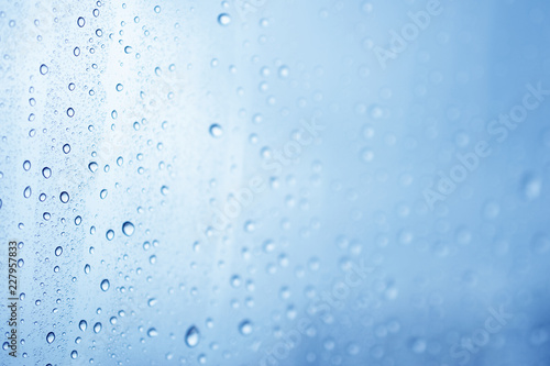 Water rain drop onto the window glass background.