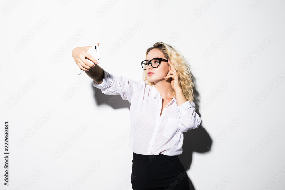 Closeup of beautiful playful business woman making selfie on isolated white background Closeup of beautiful playful business woman making selfie on isolated white background