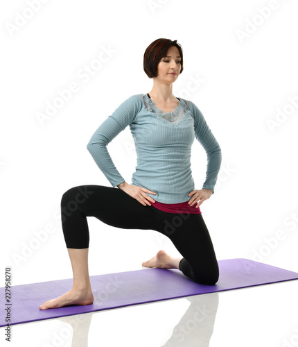 Female fitness instructor doing stretching for hands legs abdominals bar exercise in gym work out isolated on white 