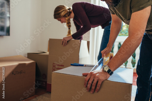 Couple packing their items in packing boxes photo