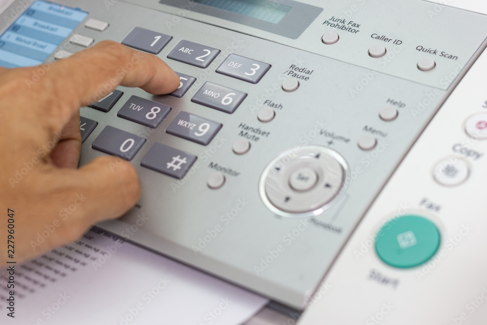 Hand man are using a fax machine in the office, Business concept office life Hand man are using a fax machine in the office, Business concept office life