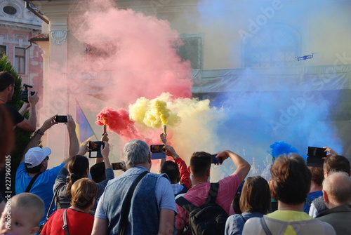 Steam colored in Romanian flag above celebrating people in Romania