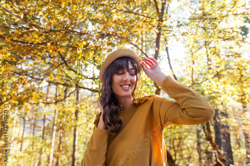 Portrait of pretty fashion young woman enjoying at autumn day