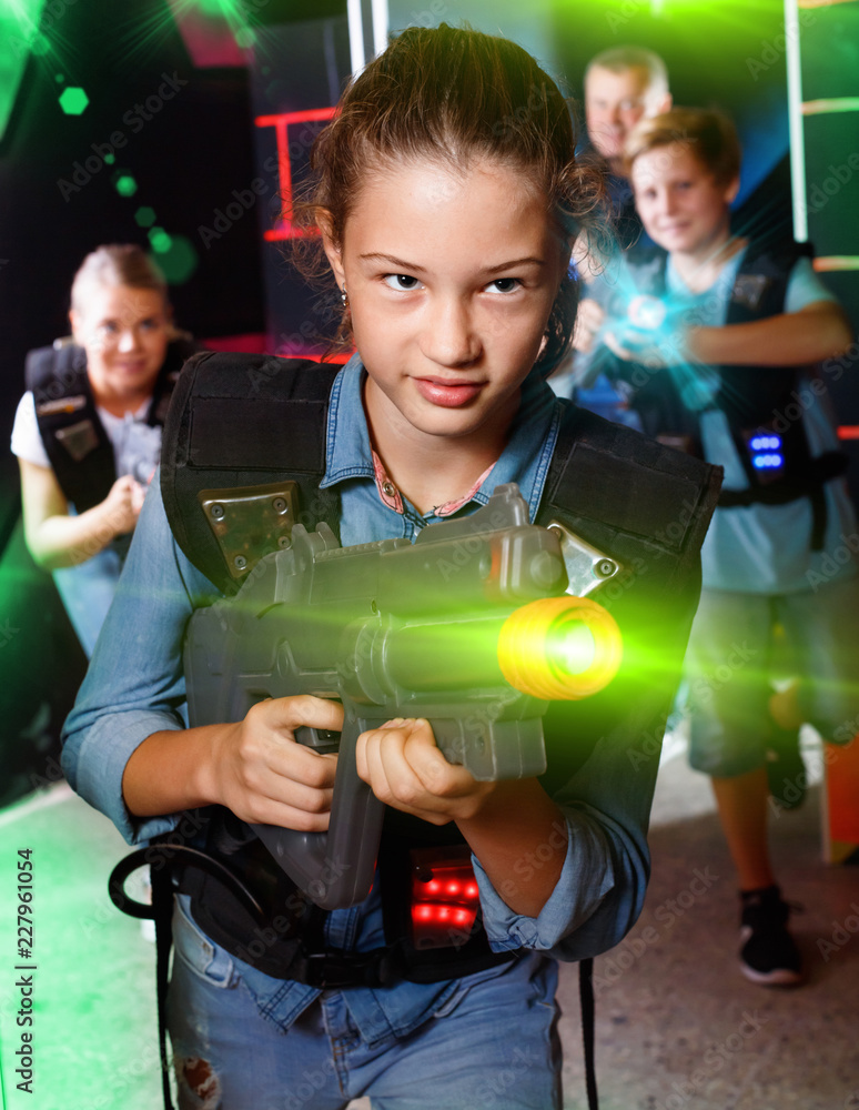 Portrait of teenager girl with laser gun having fun with her fam Stock