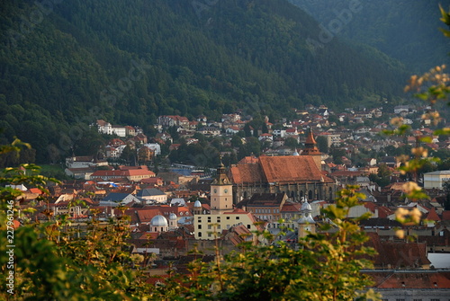 Scenery of Brasov city centre with Black Church sorrounded by mountains, Romania