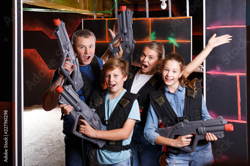 Cheery teens and parents with laser guns