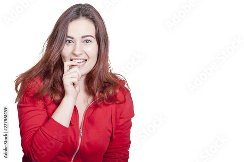 woman in red red hoodie shirt makes an embarressed expression gesturing that she has got busted