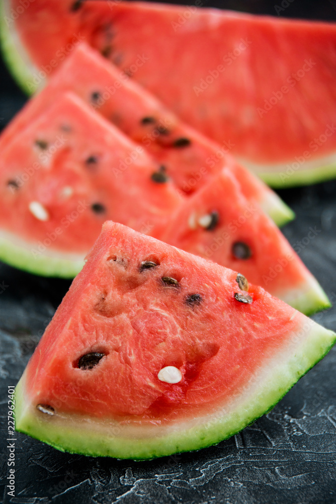 Slices of fresh ripe watermelon on a dark background. Slices of fresh ripe watermelon on a dark background.