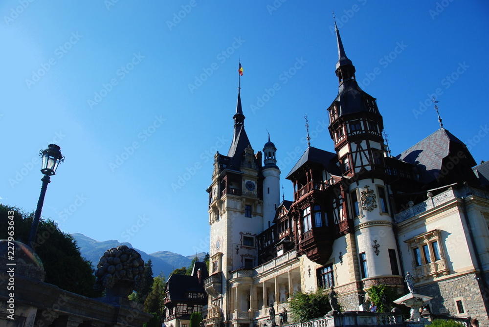 Peles Castle in summer sorrounded by Carpathian Mountains, Romania Peles Castle in summer sorrounded by Carpathian Mountains, Romania