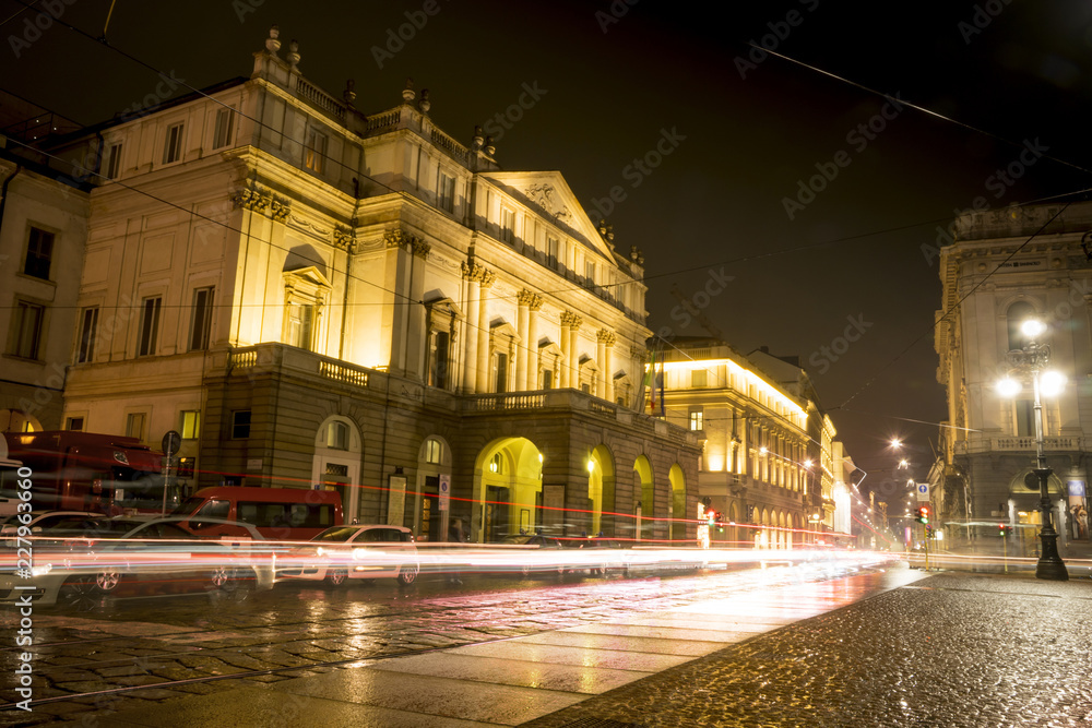 Teatro alla Scala (Theatre La Scala) at night in Milan, Italy. Light trails of car traffic.