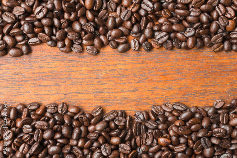 Coffee beans on wooden table with copy space for text or image. Coffee beans on wooden table with copy space for text or image.
