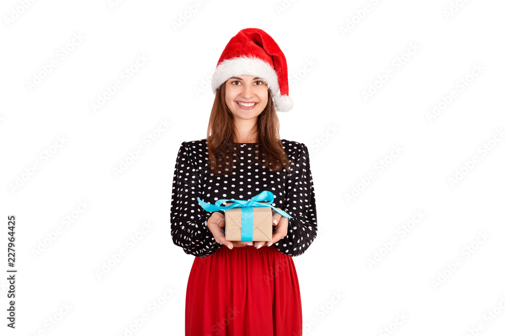 Cheerful happy girl in christmas hat giving a present with blue ribbon. isolated on white background. holidays concept Cheerful happy girl in christmas hat giving a present with blue ribbon. isolated on white background. holidays concept