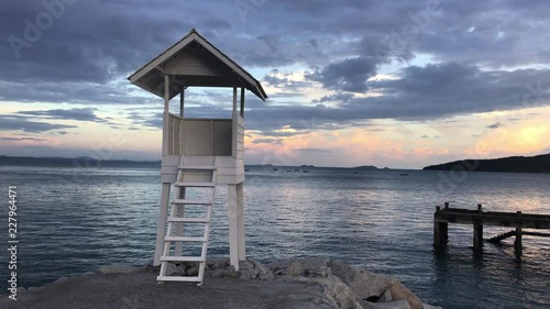 lifeguard tower on the beach. Wood white pavilion at shore.