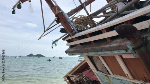 Fishing boats in the harbor. Shipwreck on the beach. An old wrecked wooden boat near the shore with the beach.
