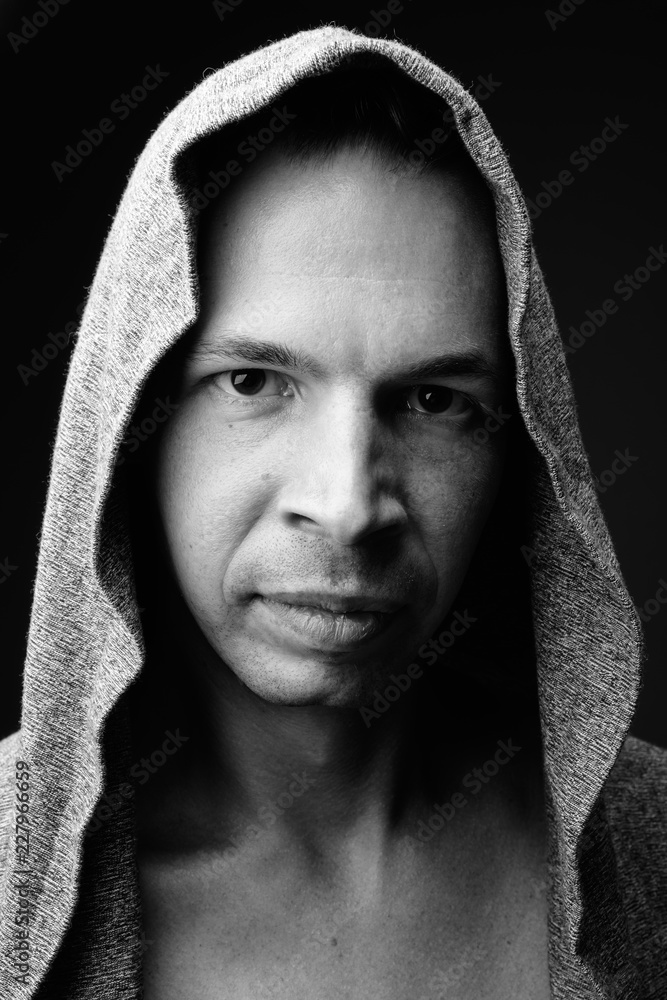 Rebellious man against black background in black and white Rebellious man against black background in black and white