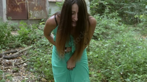 sexual assault, aggression. Depressed wound young woman cries alone in the woods