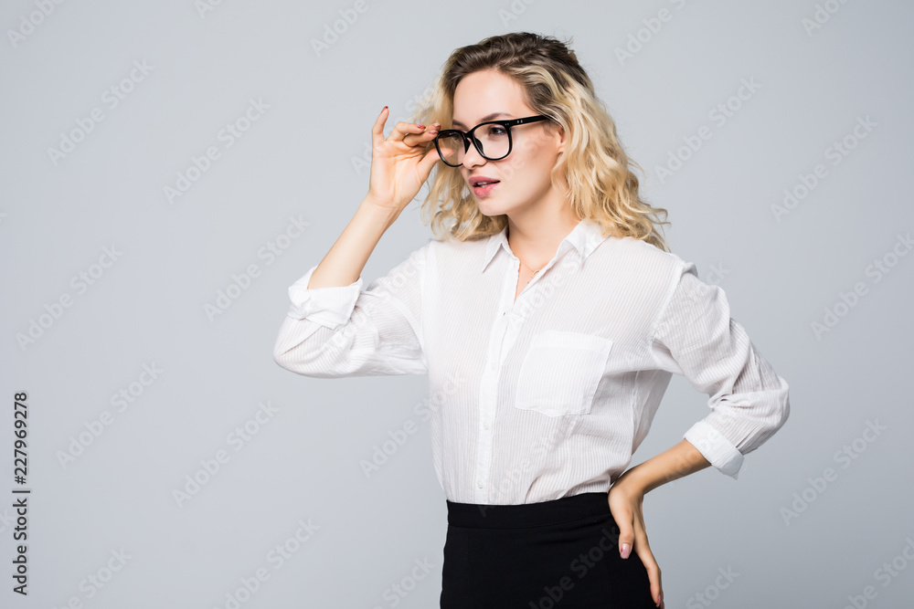 Portrait of young business woman wearing glasses isolated on grey background. Portrait of young business woman wearing glasses isolated on grey background.
