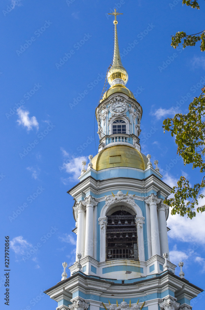 fragment Of the bell tower of St. Nicholas Cathedral with a Golden spire and a cross, St. Petersburg