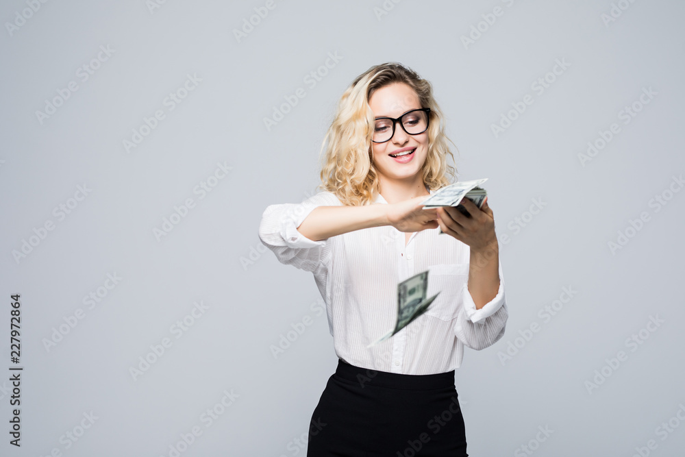 Beautiful young businesswoman scattering money isolated on white background Beautiful young businesswoman scattering money isolated on white background