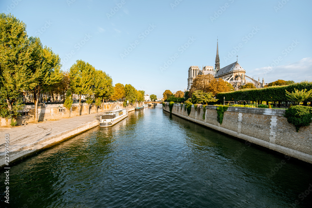 Landscape view on the famous Notre-Dame cathedral on Seine river during the morning light in Paris, France