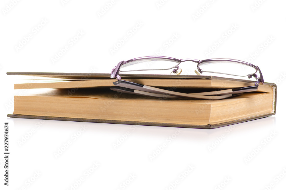 Books and glasses for vision on a white background. Isolation. Books and glasses for vision on a white background. Isolation.