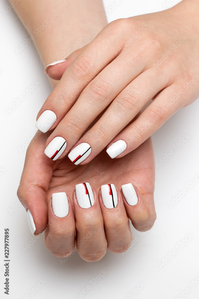 delicate white manicure with black-red stripes on square short nails on a  white background close-up Stock Photo | Adobe Stock