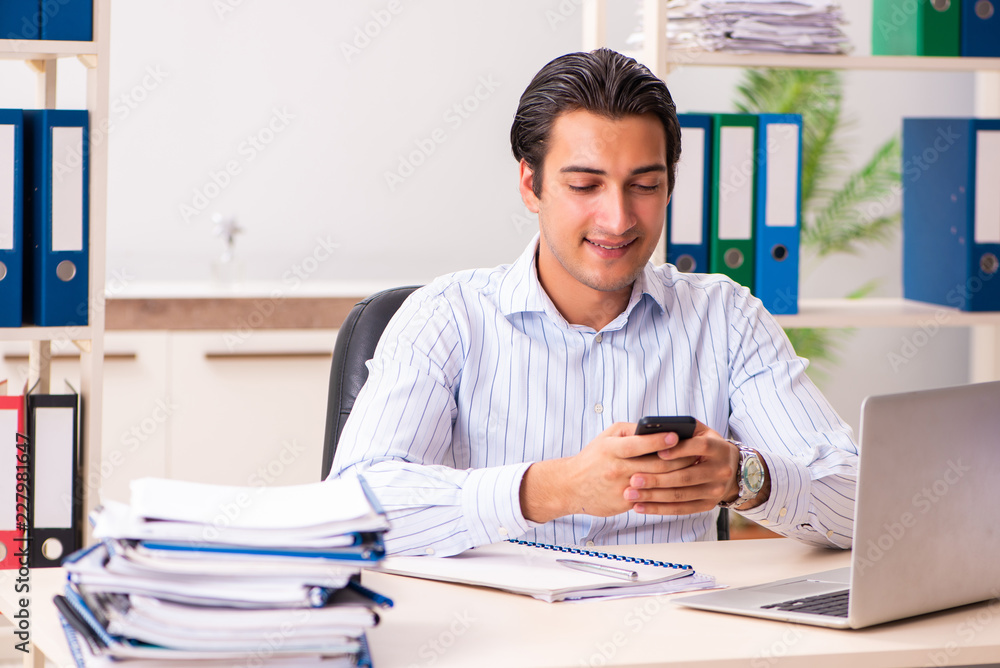 Fototapeta premium Young employee sitting at the office