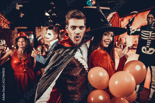 Young Happy Couple in Costumes at Halloween Party