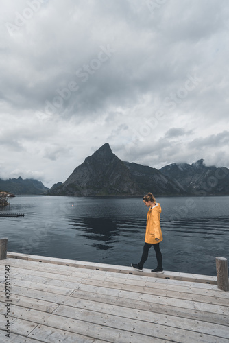 Girl balancing on a harbor