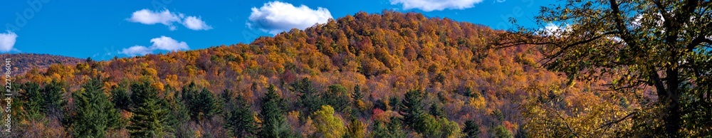 Panoramic view of an autumn scene in Vermont mountains near Stowe Panoramic view of an autumn scene in Vermont mountains near Stowe