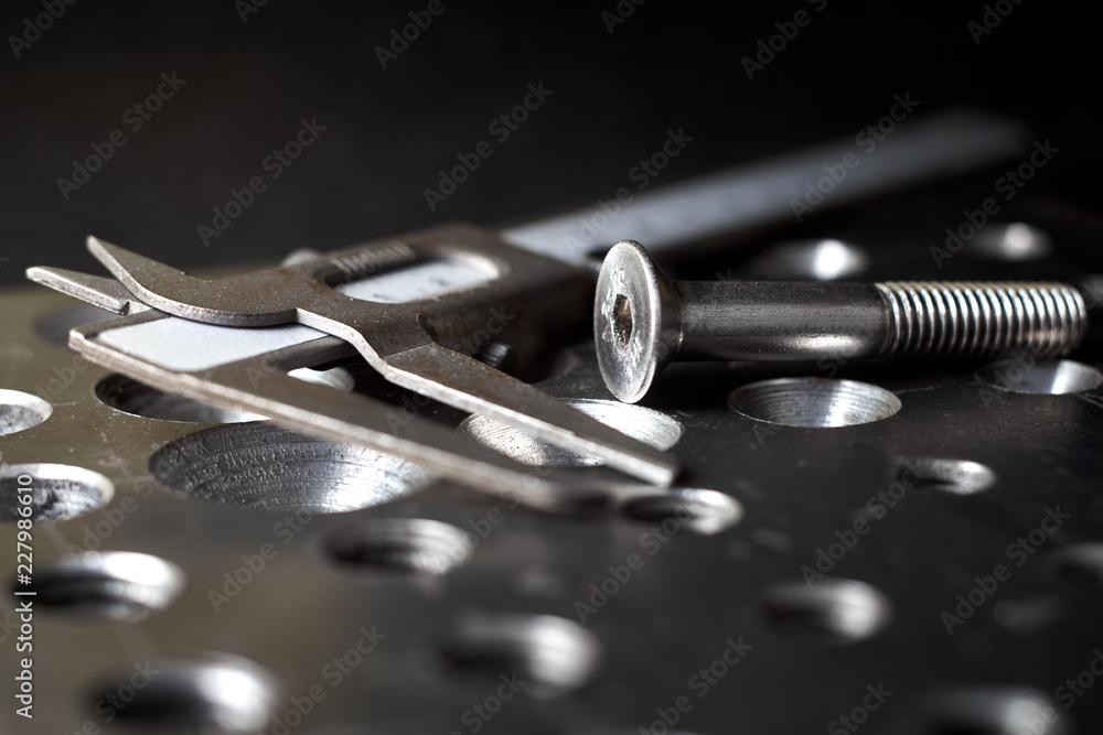 steel plate with a screw and a caliper steel plate with a screw and a caliper