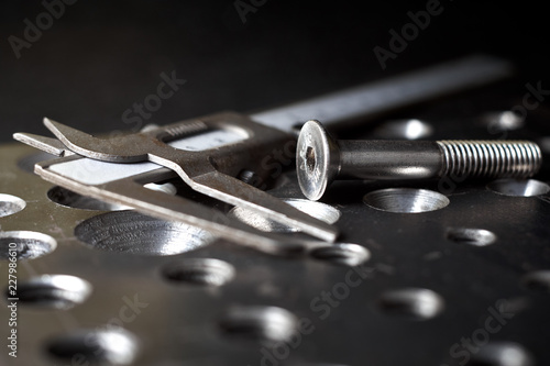 steel plate with a screw and a caliper