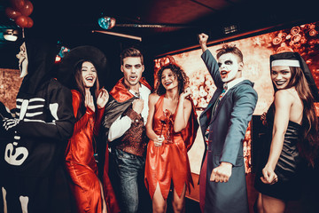 Group of Friends in Halloween Costumes Dancing