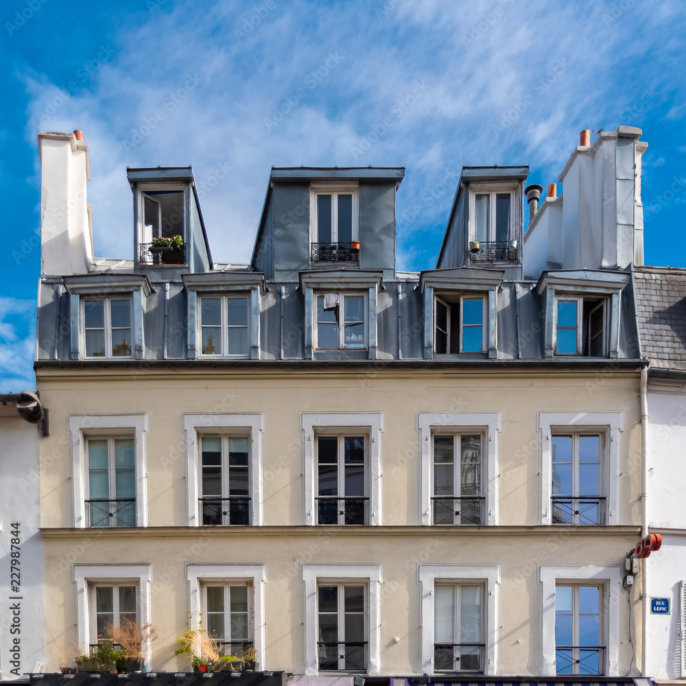 Obraz premium Paris, beautiful house in Montmartre, typical parisian facade rue Lepic
