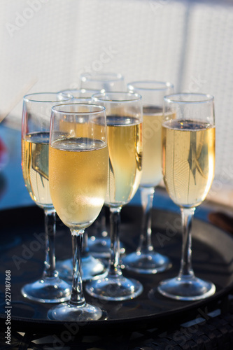 Glasses with champagne on a tray
