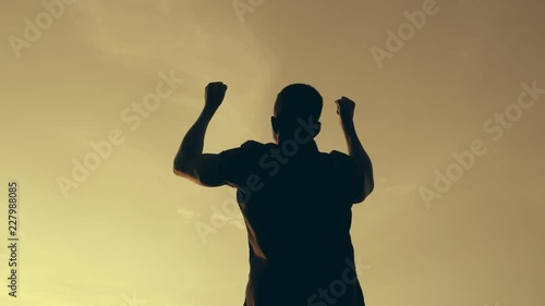silhouette of black man who rejoices in happiness. success, winning -slow motion