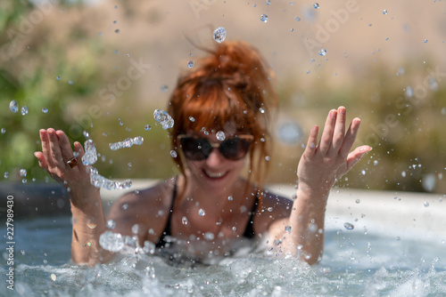 Tableau sur toile Girl laughing in hot tub
