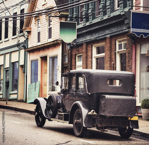 Old car parked on the street of an old town