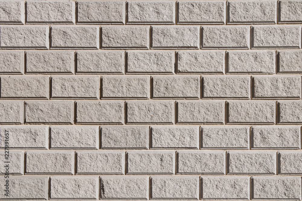 The texture of a stone wall of rectangular stones The texture of a stone wall of rectangular stones