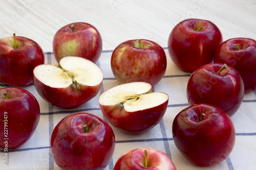 Fresh raw red apples on white wooden background, side view. Closeup.