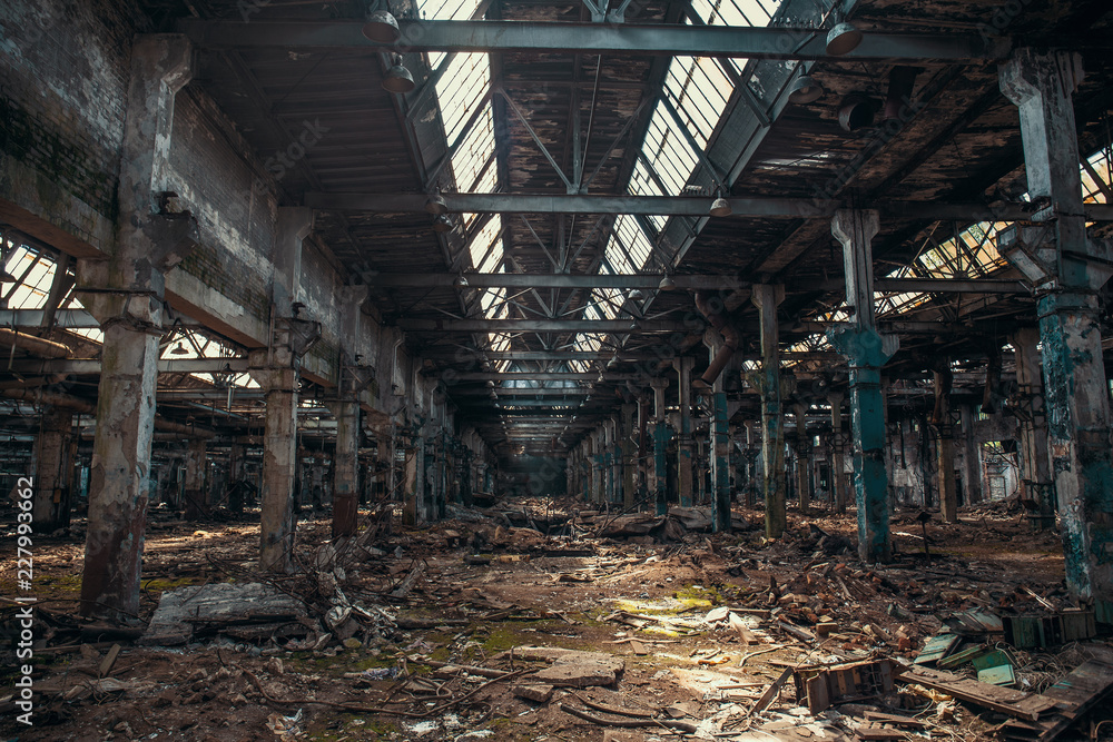 Abandoned ruined industrial warehouse or factory building inside, corridor view with perspective, ruins and demolition concept Abandoned ruined industrial warehouse or factory building inside, corridor view with perspective, ruins and demolition concept