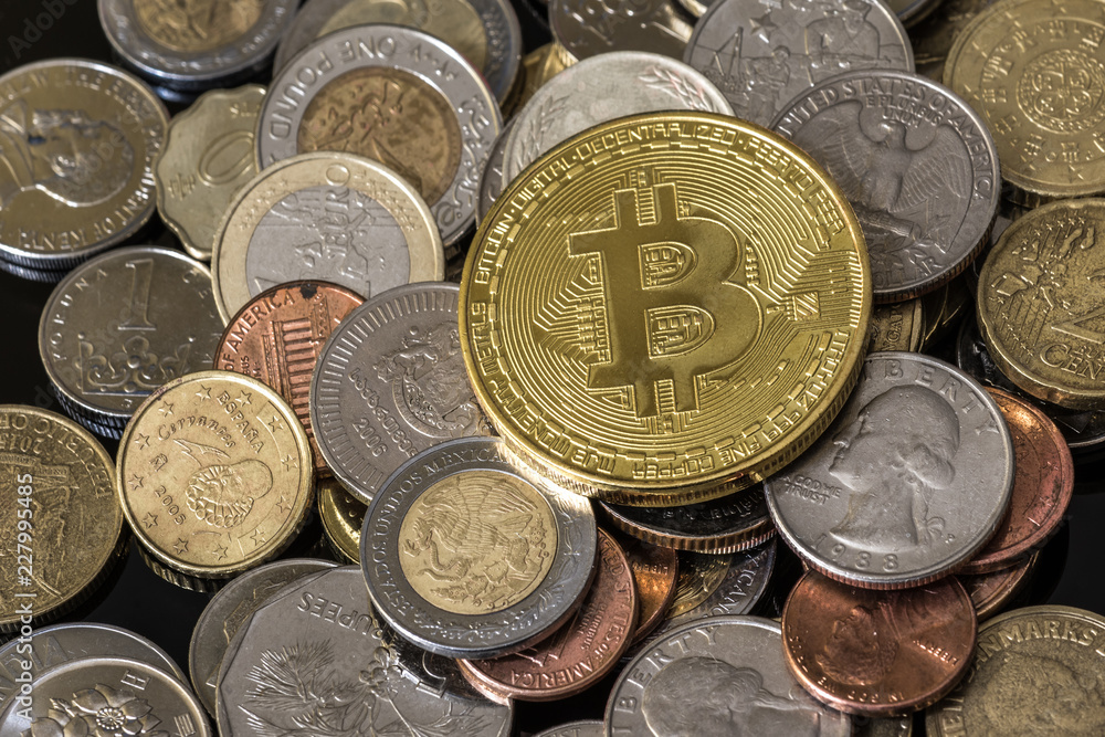 Golden bitcoin over a pile of coins. Golden bitcoin over a pile of coins.