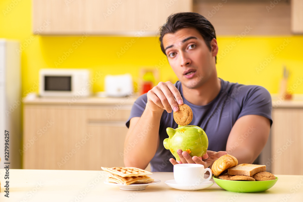 Young man in unhealthy food concept Young man in unhealthy food concept